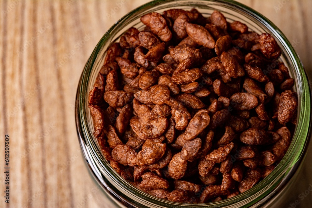 Jar of chocolate cereal on a wooden surface Jar of chocolate cereal on a wooden surface