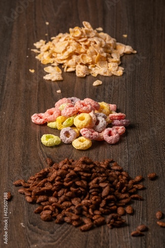 Types of breakfast cereal presented on a wooden surface