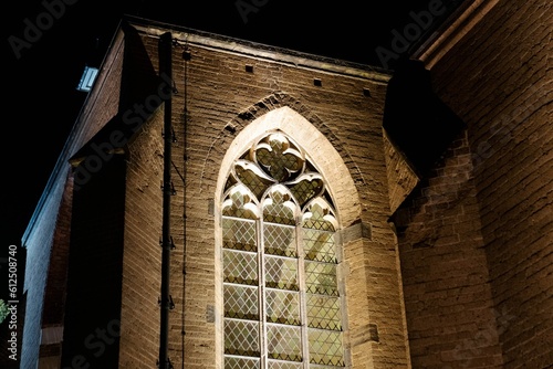 Close-up shot of a gothic-styled window on a stone wall