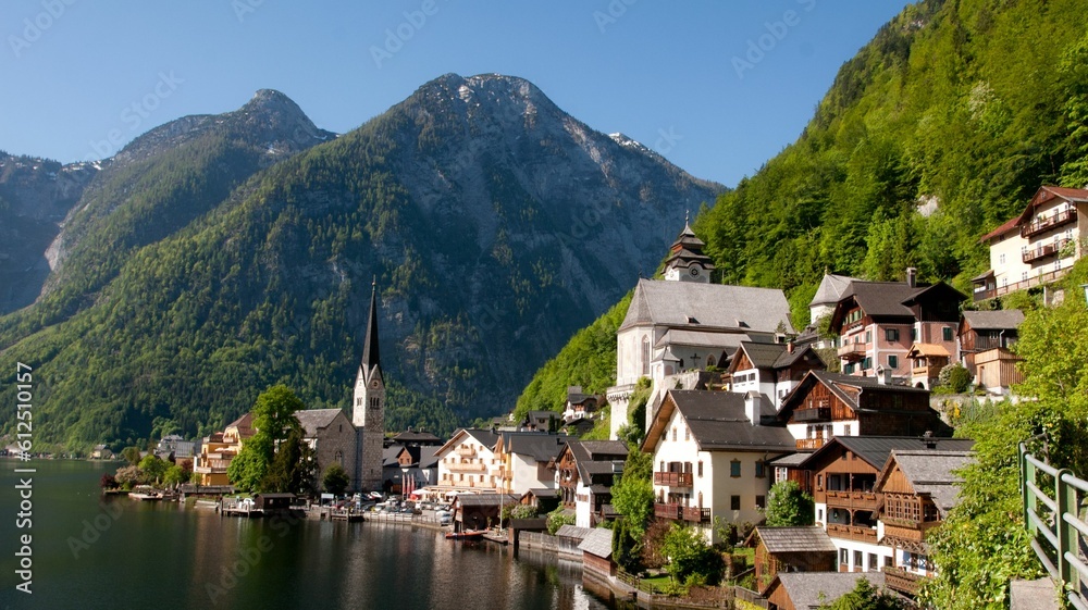 Aerial view of Hallstatt lake surrounded by dense trees and buildings