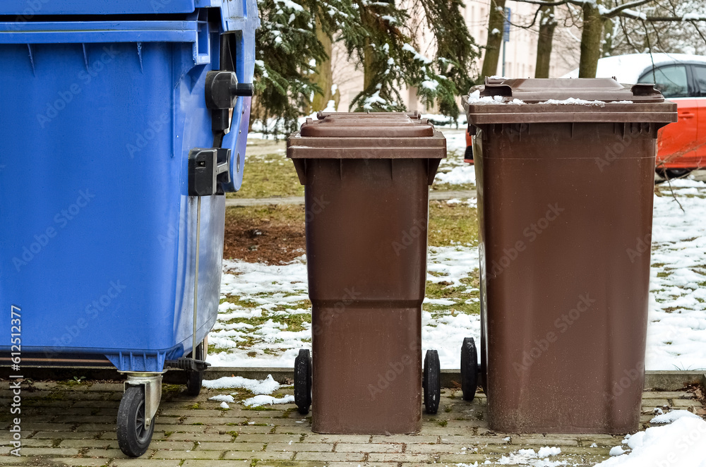View of garbage containers in city on winter day View of garbage containers in city on winter day