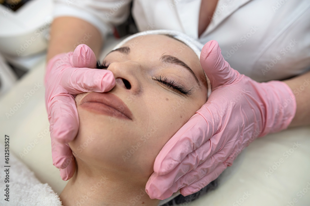 Young woman receive face massage at spa salon Young woman receive face massage at spa salon