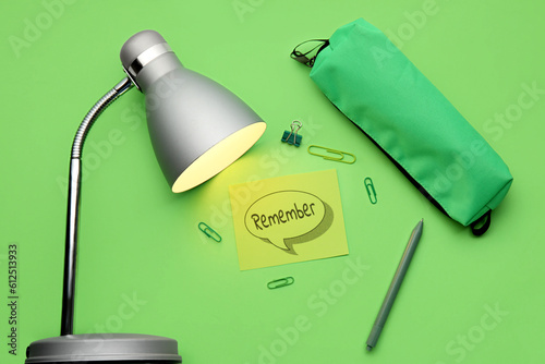 Canvas Print Reminder with stationery and glowing lamp on green background