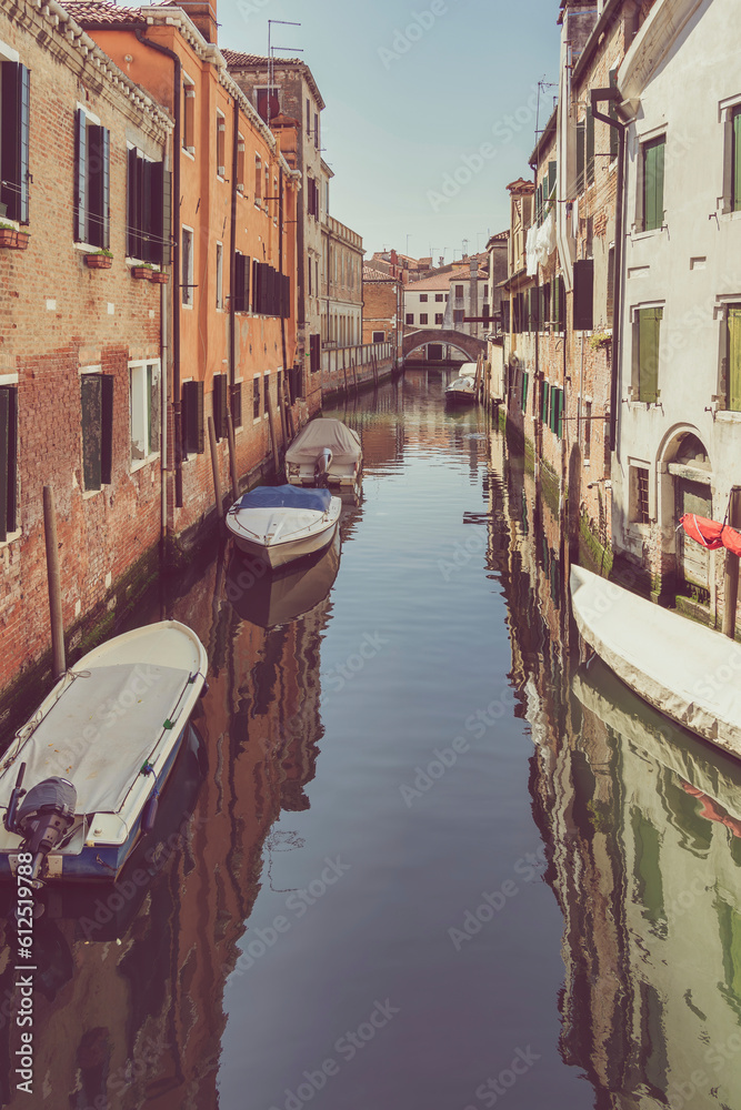 Picturesque Scene from Venice with many boats parked on the narrow water canals.