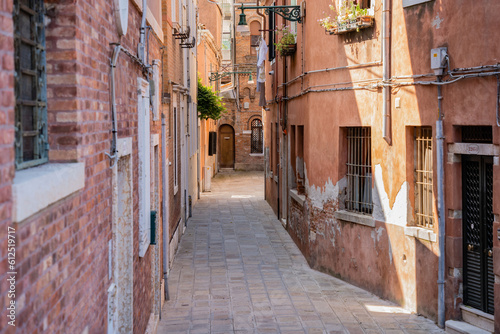 Scene with the narrow streets and the old medieval red brick buiuldings in Venice  Italy.