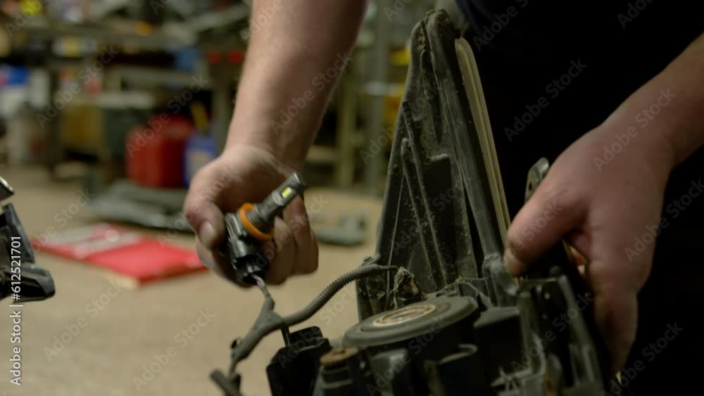 Mechanic checking car parts while working in auto repair shop Mechanic checking car parts while working in auto repair shop