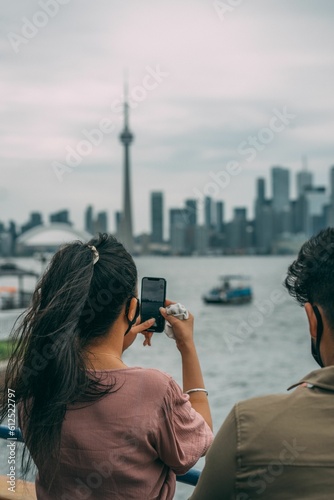 Photography Vertical of a South East Asian couple taking photo of the view of Toronto, Canad