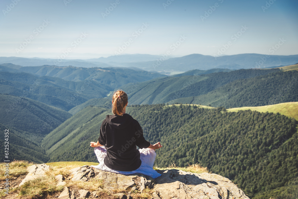 Fototapeta premium Young woman on the top of mountain