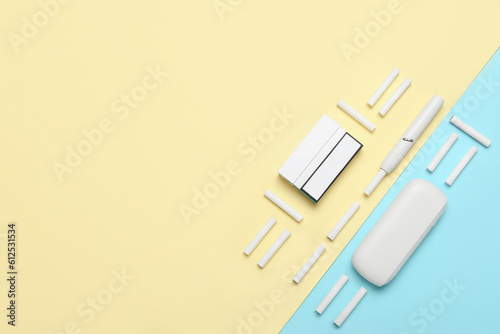 Composition with modern electronic cigar and sticks on colorful background