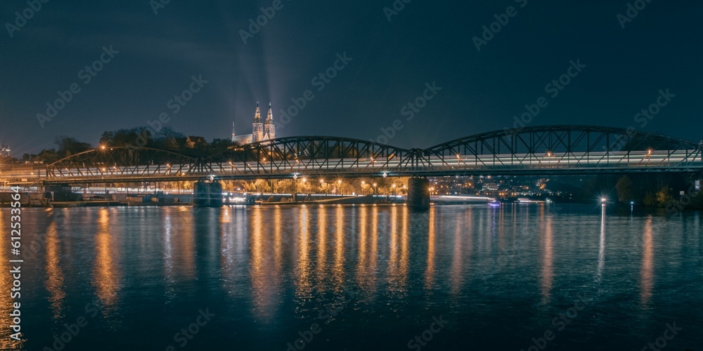 Nightlife in Prague with a railway bridge enlightened by the train