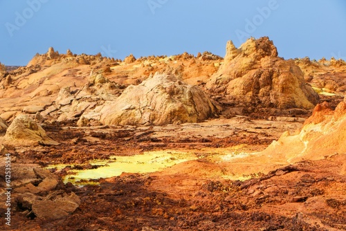 Scene of the desert with orange cliffs and sand during the daytime
