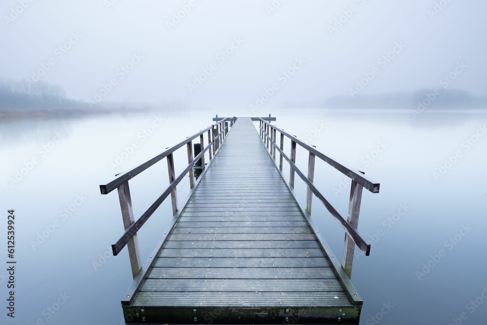 Beautiful foggy view of a pier on jetty in the Netherlands