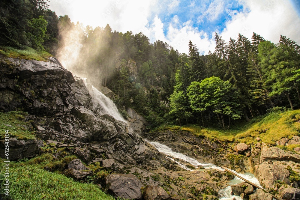Breathtaking view of the Lares Waterfall in Pinzolo on a sunny day