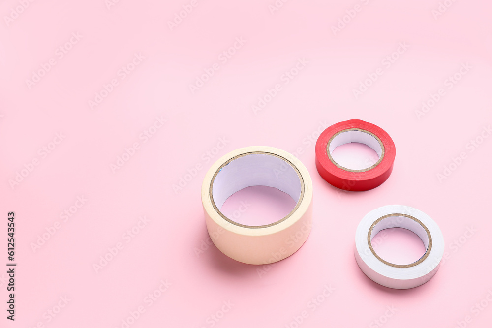 Adhesive tape rolls on pink background Adhesive tape rolls on pink background