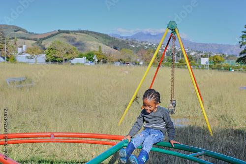 black child playing on a swing 