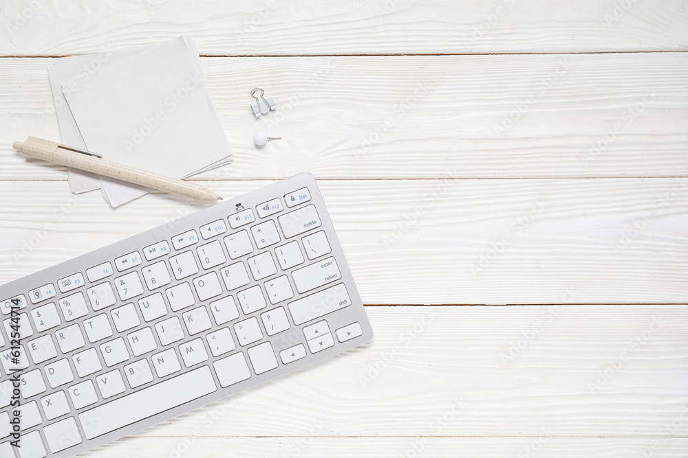 Sticky notes with keyboard on white wooden background Sticky notes with keyboard on white wooden background