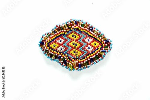 Closeup shot of a colorful handmade beadwork against the white background