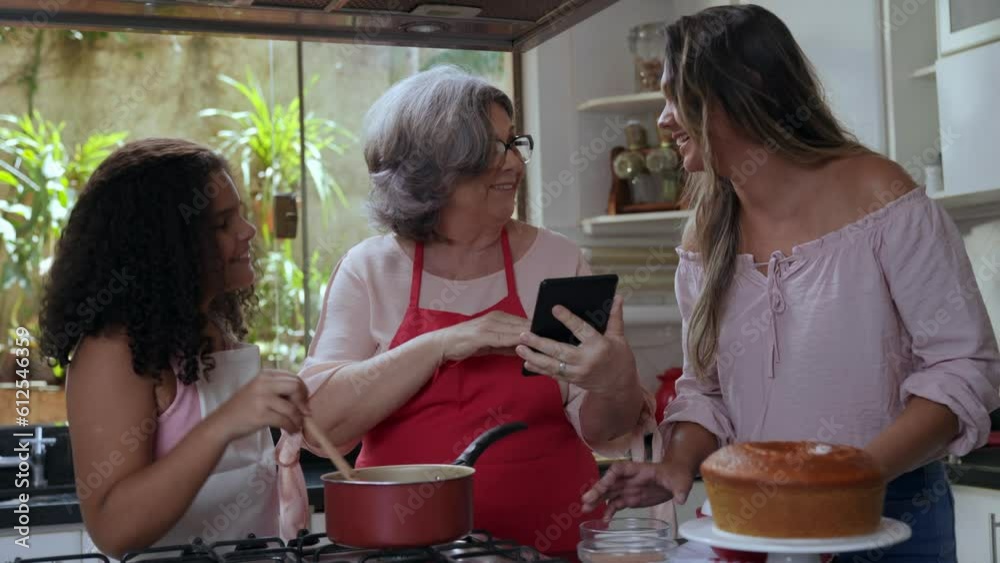 criança brasileiro fazendo brigadeiro de panela para bolo na cozinha junto com sua mãe e sua avó no dia das mães