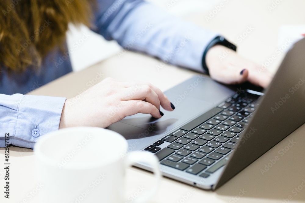 Close up of woman hands working on a laptop Close up of woman hands working on a laptop