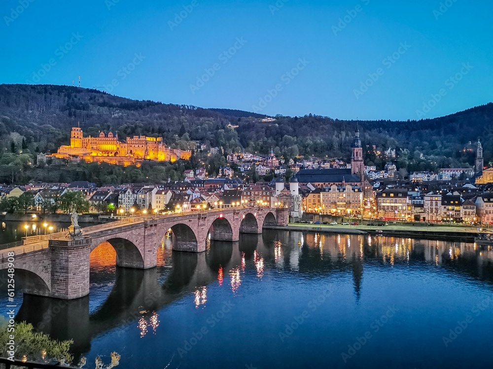 Karl Theodor Bridge against the scenic Heidelberg cityscape in the evening