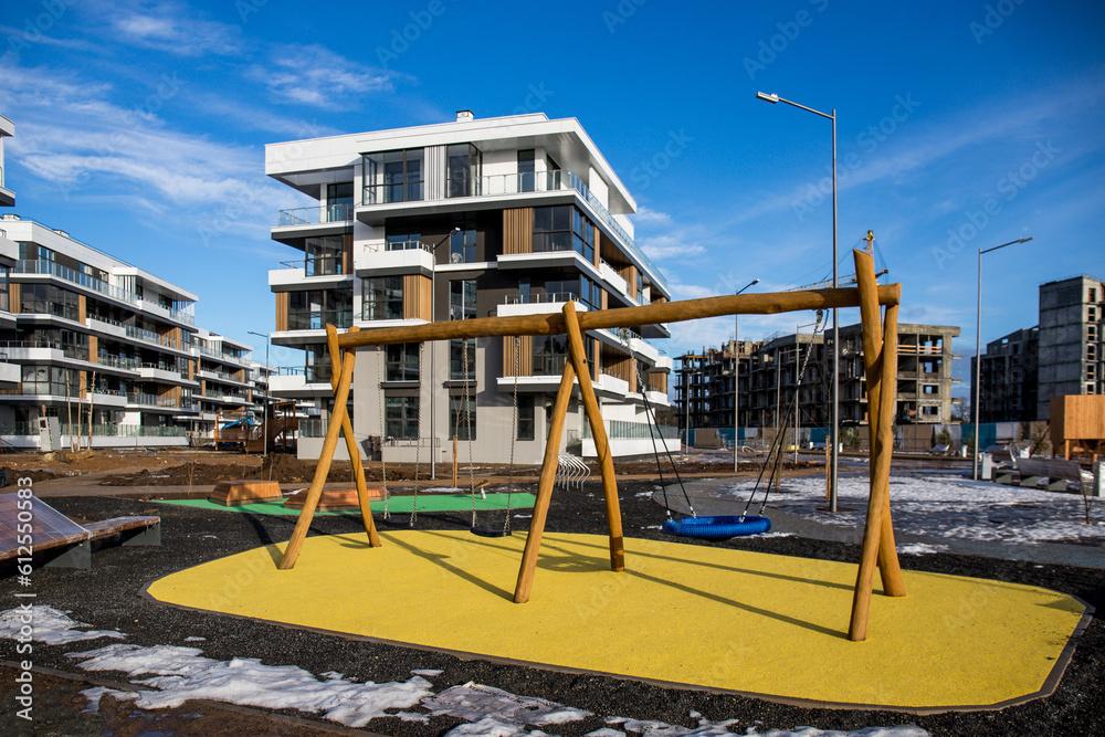 View of public park with newly built modern block of flats in winter/spring View of public park with newly built modern block of flats in winter/spring