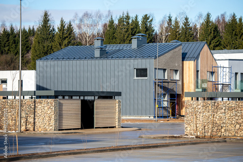 Wallpaper Mural An almost finished new suburban house construction project with metal scaffold. Concept of real estate development, self build home, property investment Torontodigital.ca