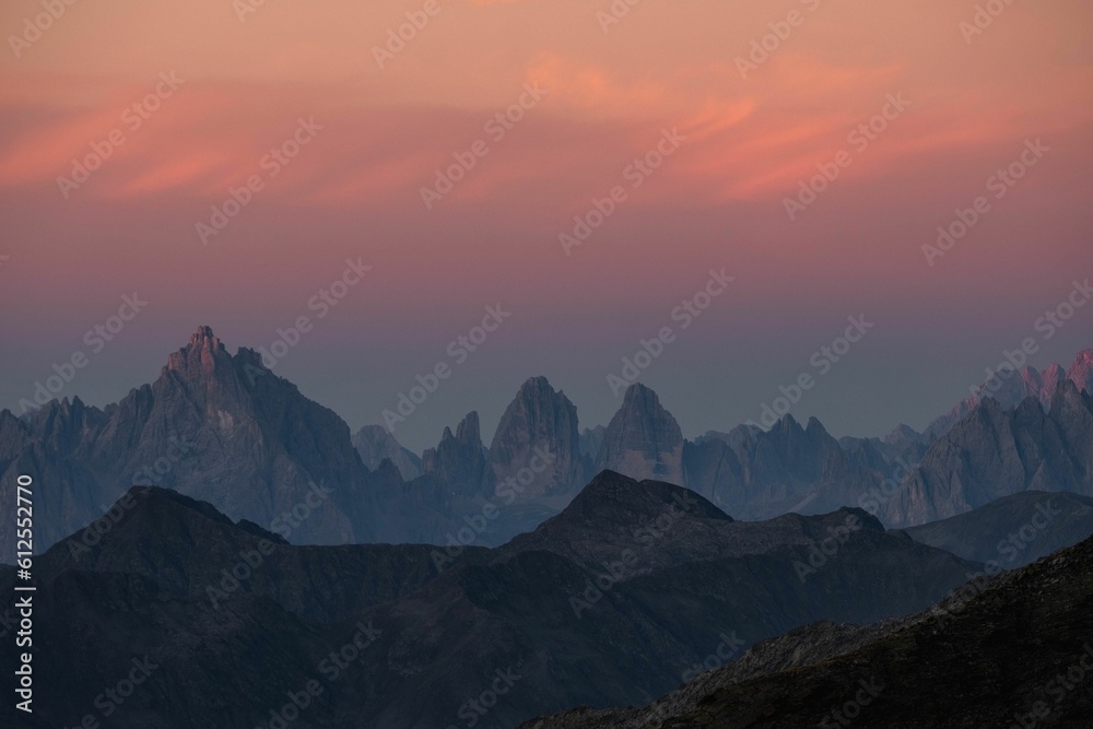 Silhouette of mountains under colorful sky during sunset