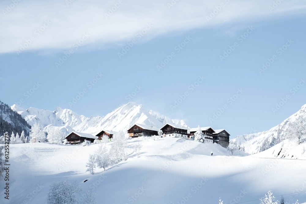 Aerial view of snow covered mountain landscape with buildings