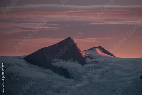 Silhouette mountains under colorful sky during sunset