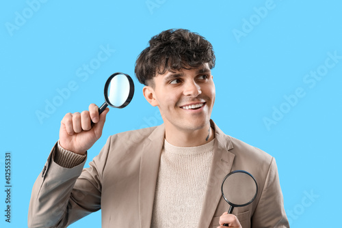 Young man with magnifiers o...