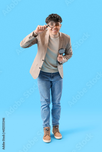 Young man with magnifiers o...