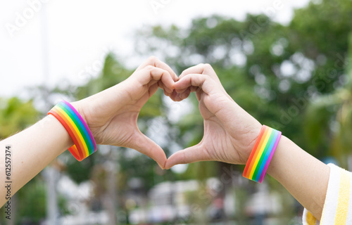 Two woman person wearing LGBT wristband make heart symbol  for homosexual love for support lgbt, community