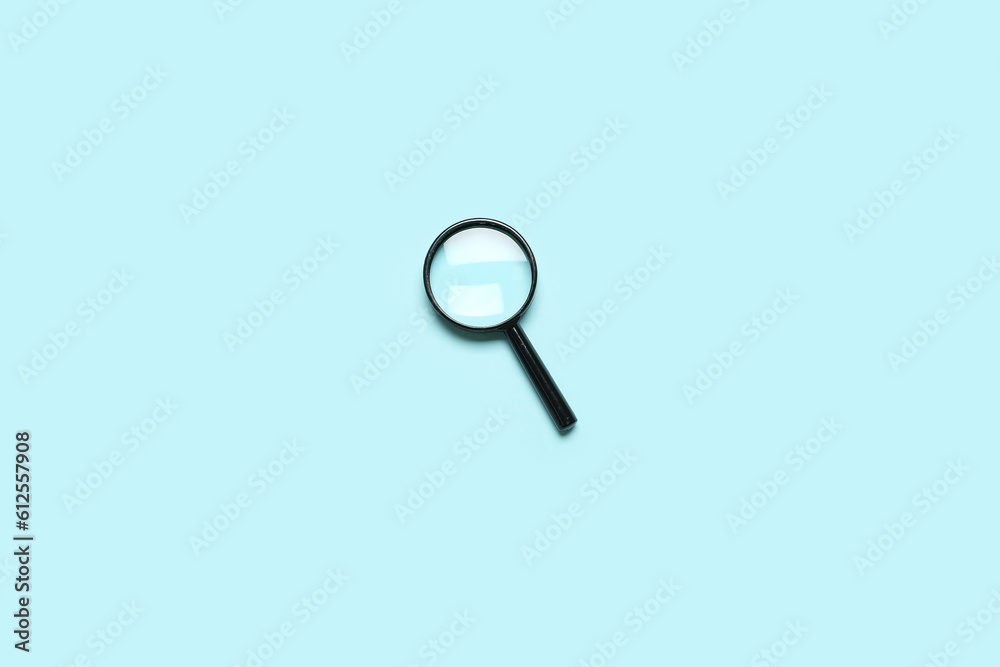 Black mini magnifier on blue background Black mini magnifier on blue background