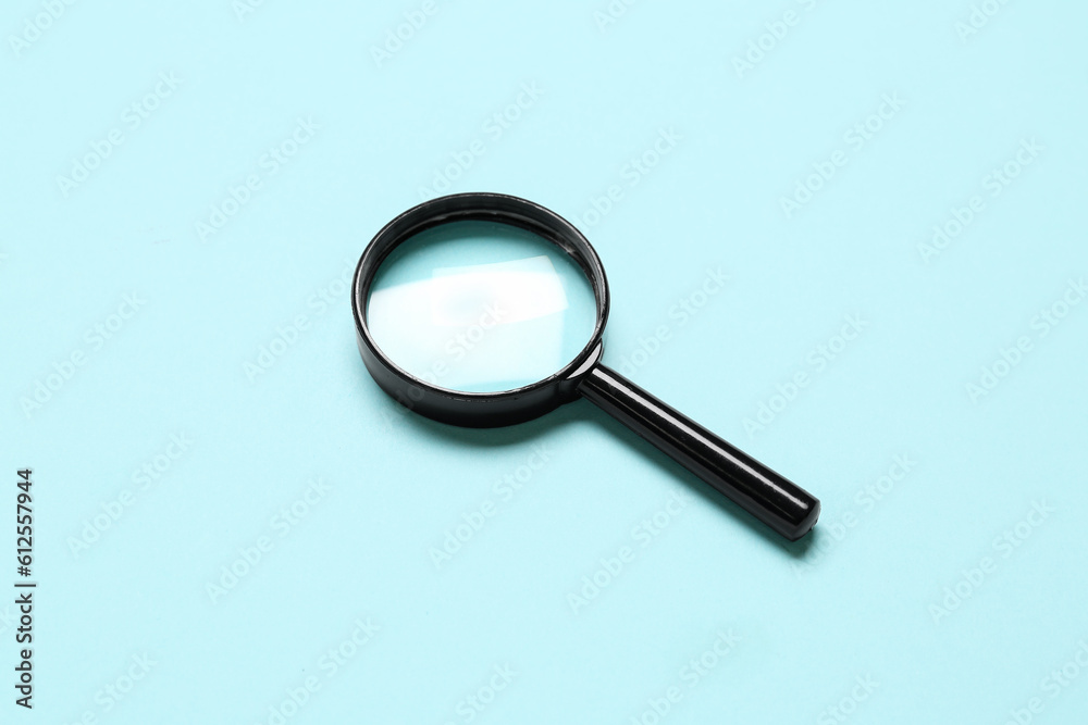 Black mini magnifier on blue background Black mini magnifier on blue background