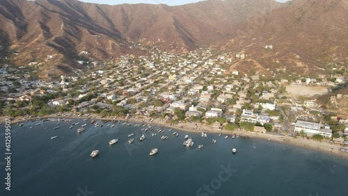 Bird's eye view of boats moored at the shore of Taganga village in Colombia surrounded by mountains photo