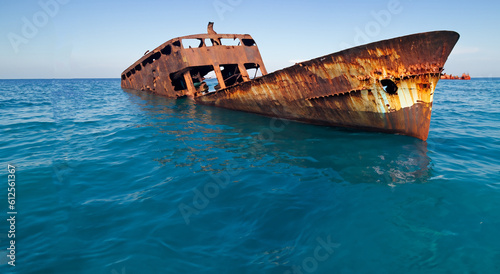 wrecked and rusty ship floating in the sea