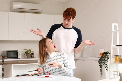 Young man proposing to his ...