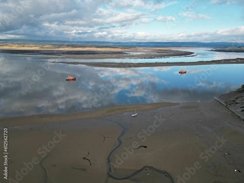 Aerial drone shot of a shallow river with reflections in Appledore village, North Devon, England photo