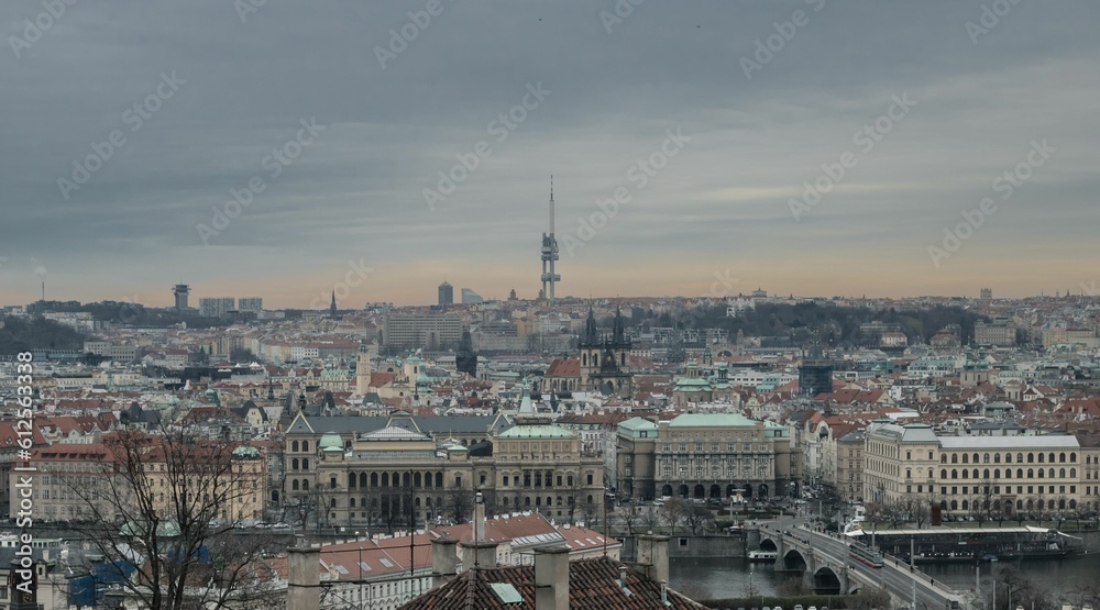 The cityscape of Prague, Czech Republic, on a cloudy day, with a bridge over the Vltava River