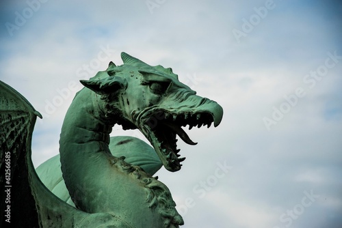 Close-up shot of a scary dragon statue in Slovenia © Akamatsuu/Wirestock Creators