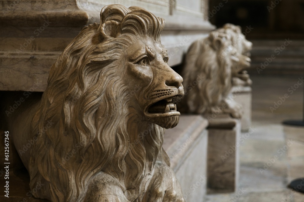 Closeup of a lion sculpture inside with blurred background