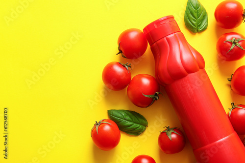 Fototapeta Naklejka Na Ścianę i Meble -  Bottle of ketchup and tomatoes on yellow background