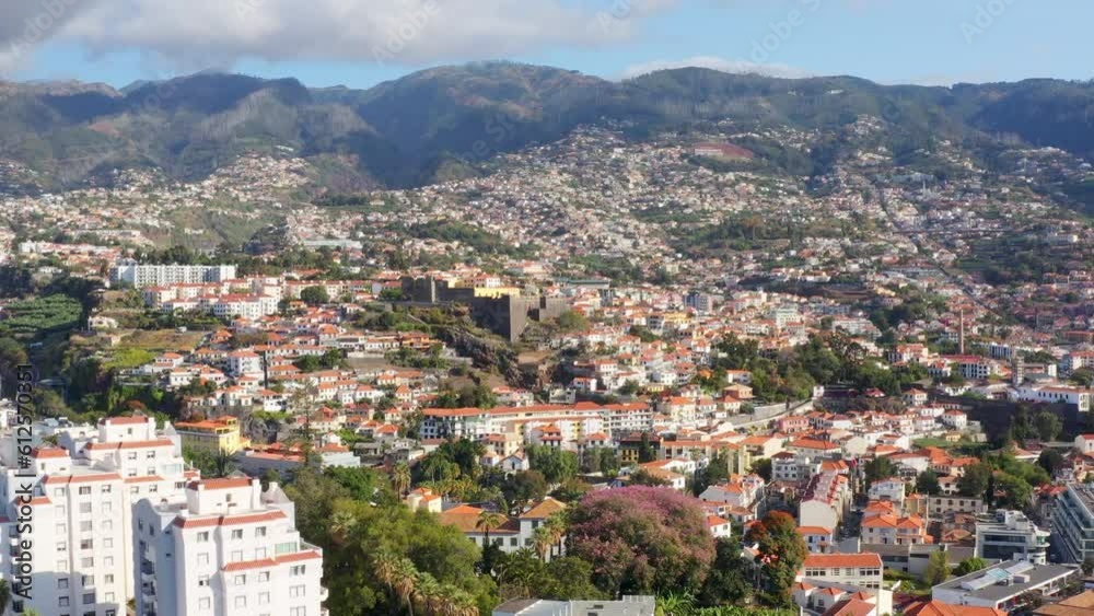 Drone view of Funchal city with mountains in background in Madeira region Drone view of Funchal city with mountains in background in Madeira region