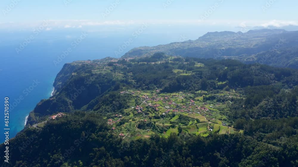 Aerial view of the scenic shores of Madeira Island under a sunny sky Aerial view of the scenic shores of Madeira Island under a sunny sky