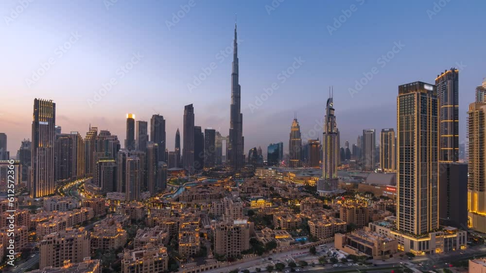 Day to night timelapse view of skyscrapers and traffic in Downtown Dubai, United Arab Emirates (UAE), business and finance concept, modern cities and skylines, zoom out.