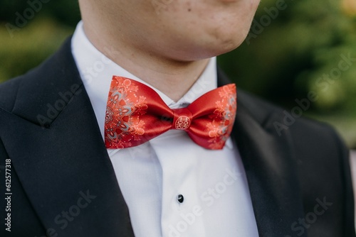 Closeup shot of a groom's suit with a Chinese traditional bow