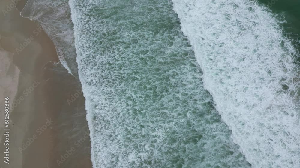 Aerial view of the sea waves splashing over the shore Aerial view of the sea waves splashing over the shore