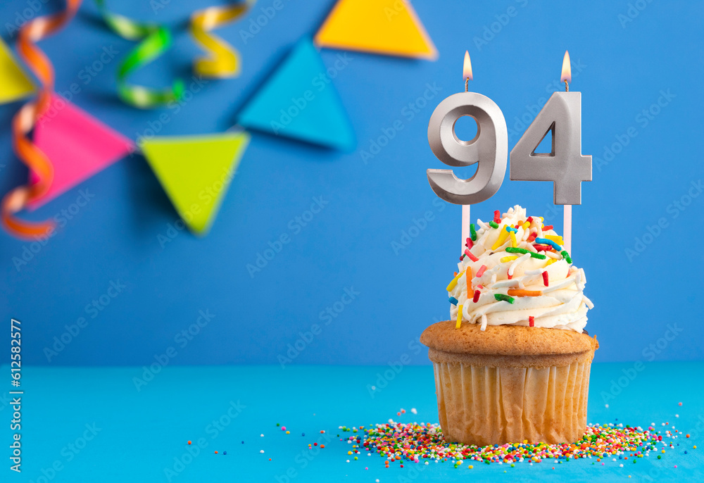 Birthday cake with candle number 94 - Blue background