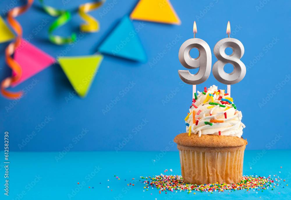 Birthday cake with candle number 98 - Blue background