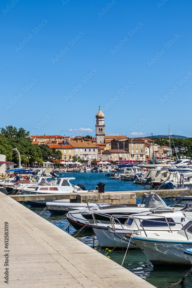 Vertical shot of the boats docked at the port of Krk city in Croatia